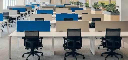 Modern open-plan office space featuring clean workstations, ergonomic chairs, and sanitized carpets provided by professional office cleaning services in Worcester, MA.