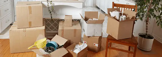 Packed moving boxes and household items in a kitchen before move-out or move-in cleaning, Worcester, MA.
